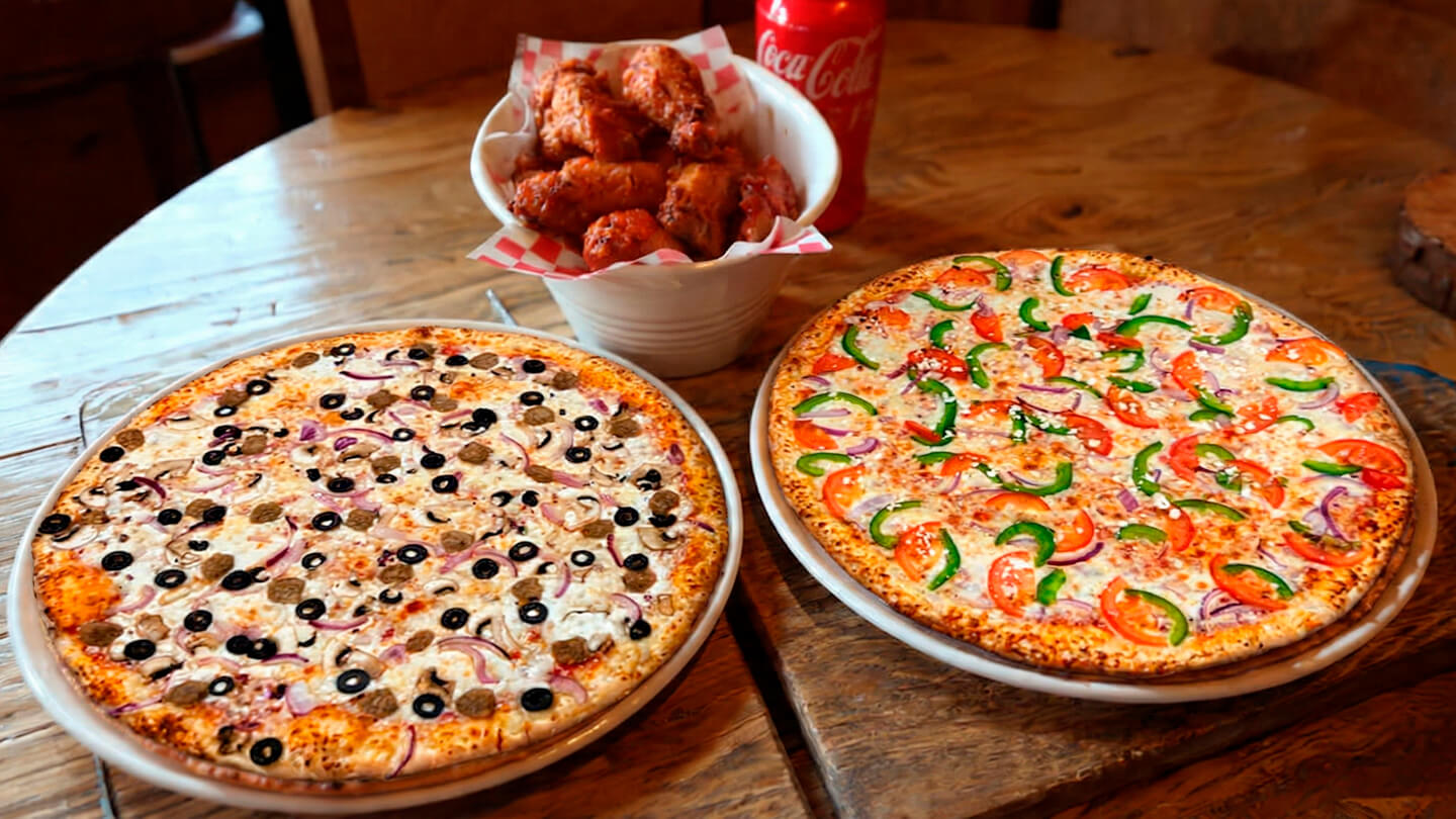Pizza and wings on a wooden table